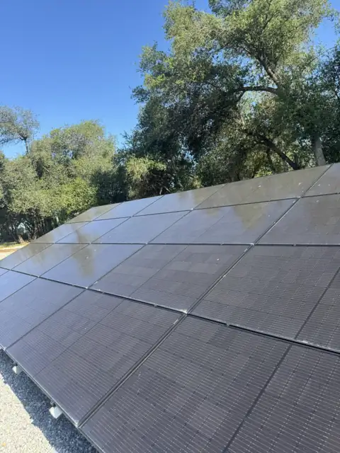Ground-mounted solar panels with a film of dust, before cleaning