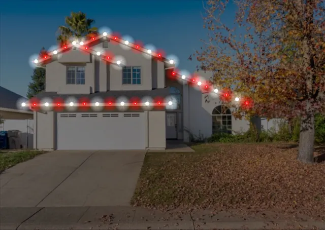 Our design mockup of a two-story house, with red and white lights drawn along the roofline